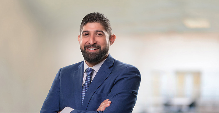 smiling man with beard in navy suit