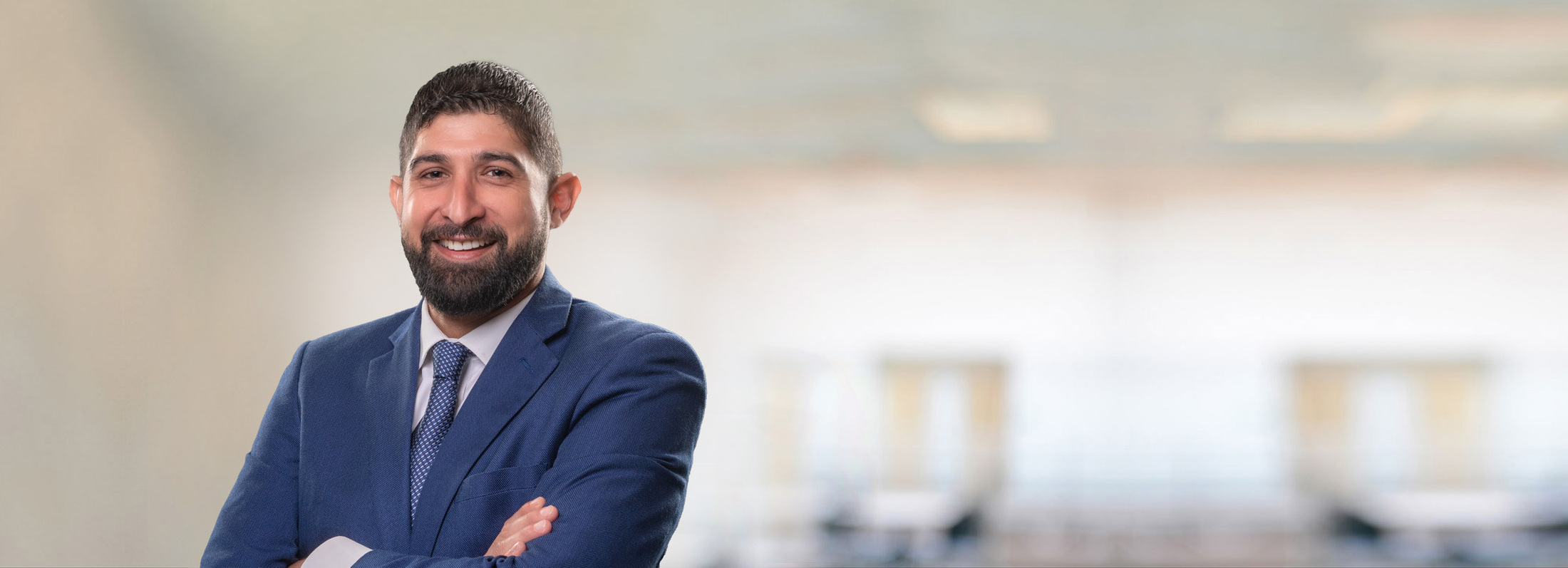 smiling man with beard in navy suit
