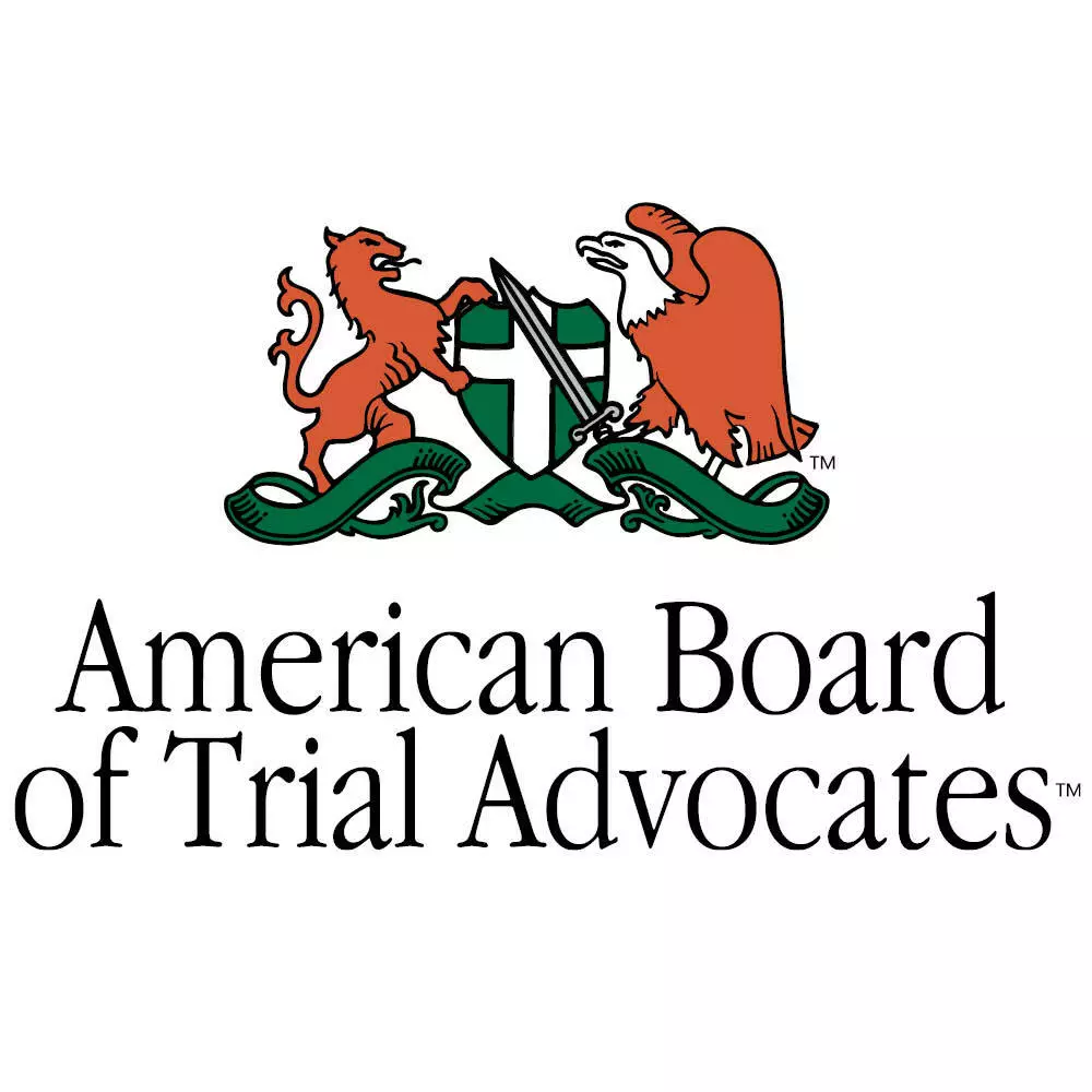 Badge with green shield and a lion and eagle