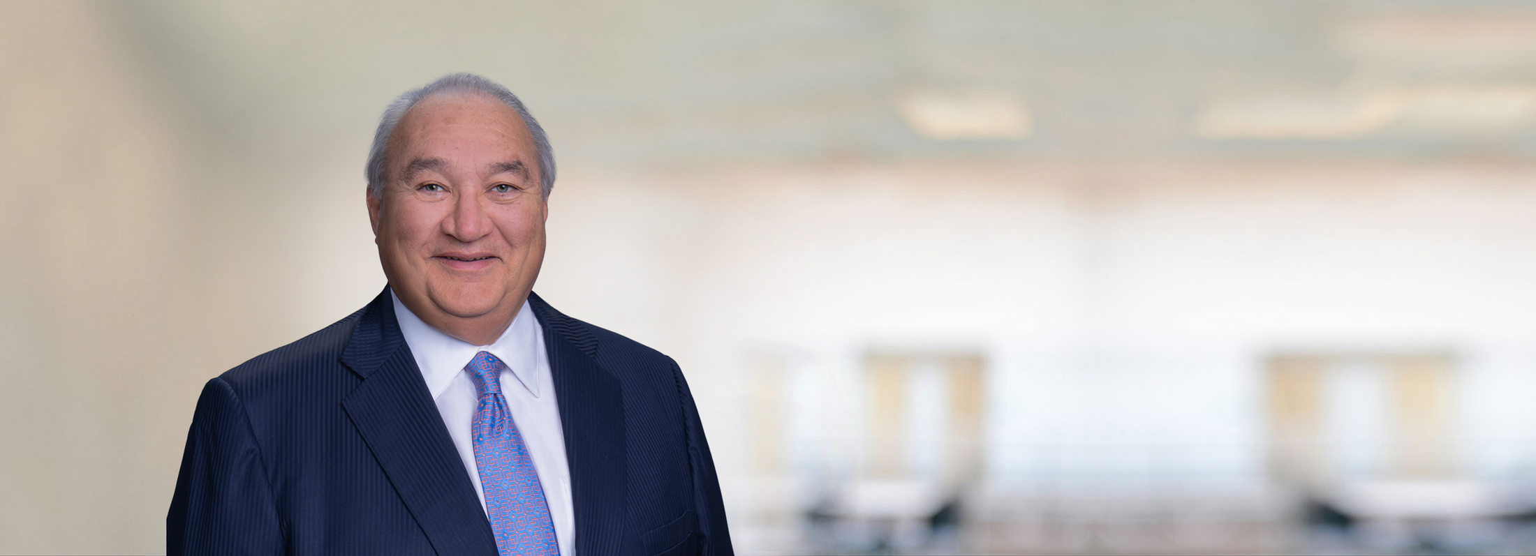 Blurry Champange Background with Blue Square NH Logo