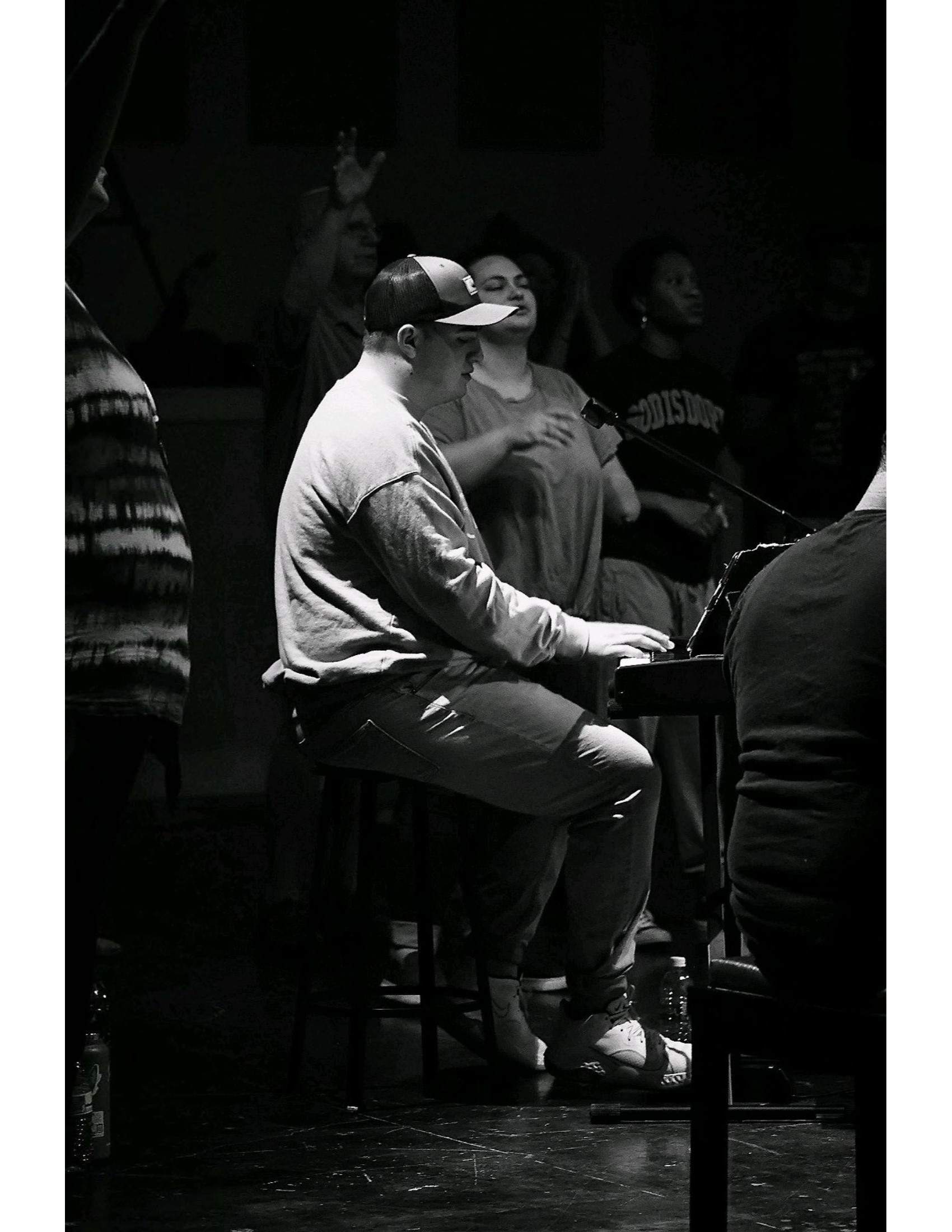 black and white photo man playing piano